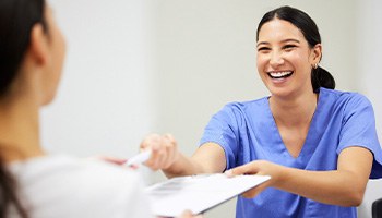 Patient in Charlottesville talking to dental team about cosmetic dentistry