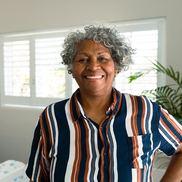 Older woman showing off her new dental bridge