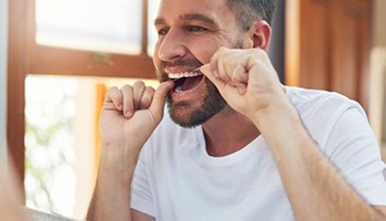 Man flossing his teeth