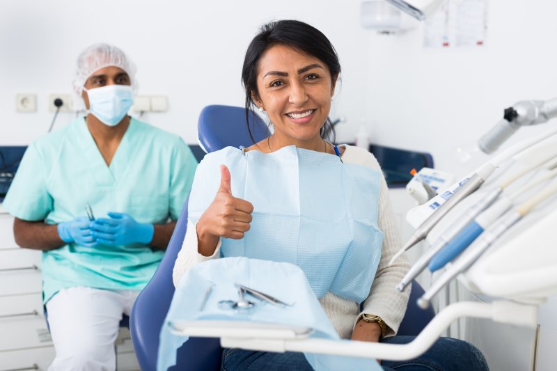 Patient giving thumps-up after checkup for dental hygiene month